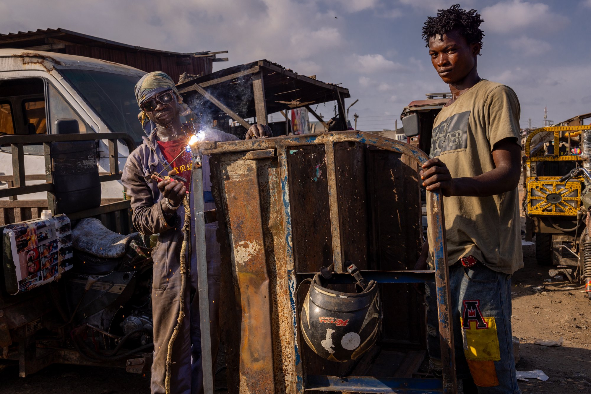 Workers welding in the scrap market