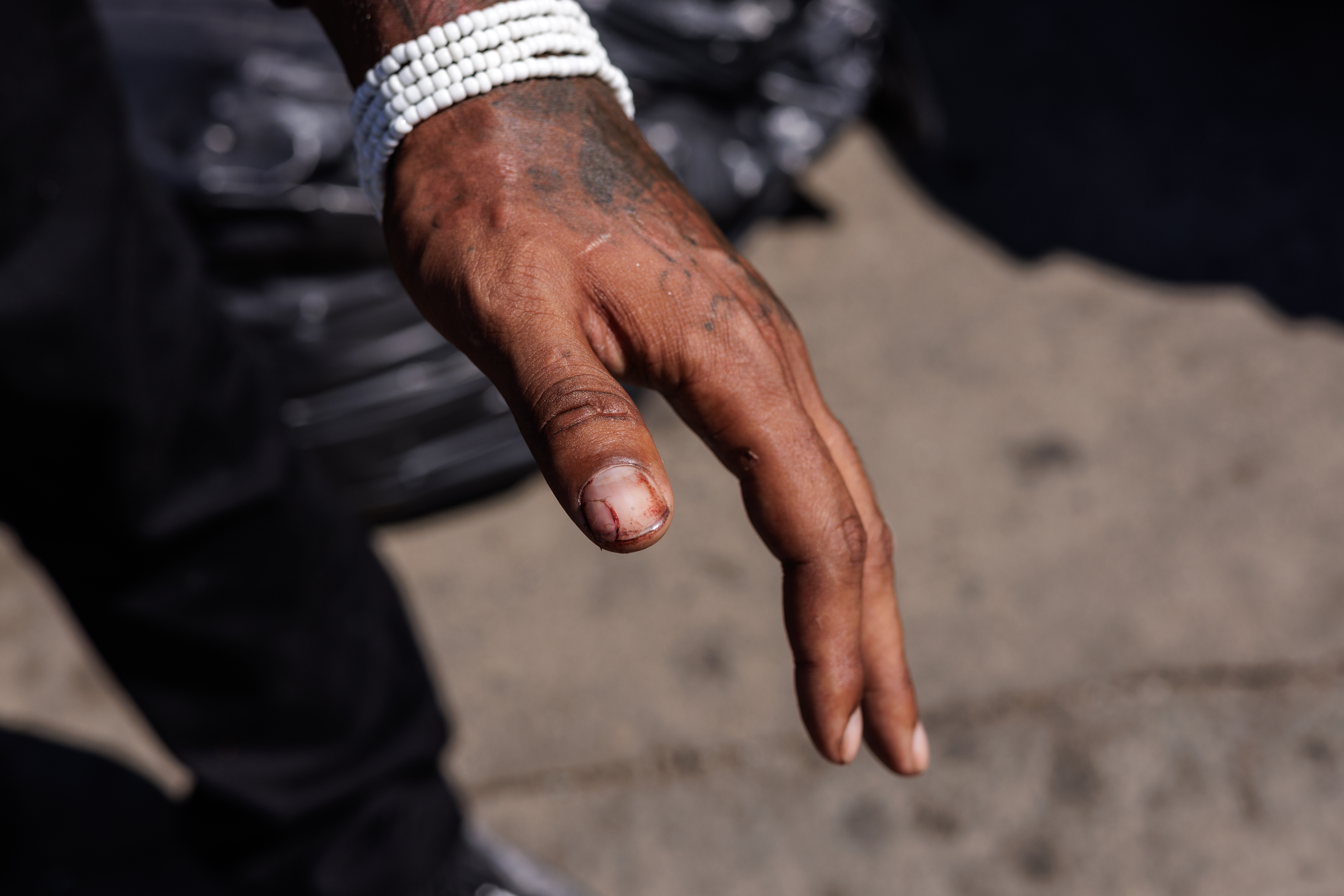Tattooed hand with white bracelet