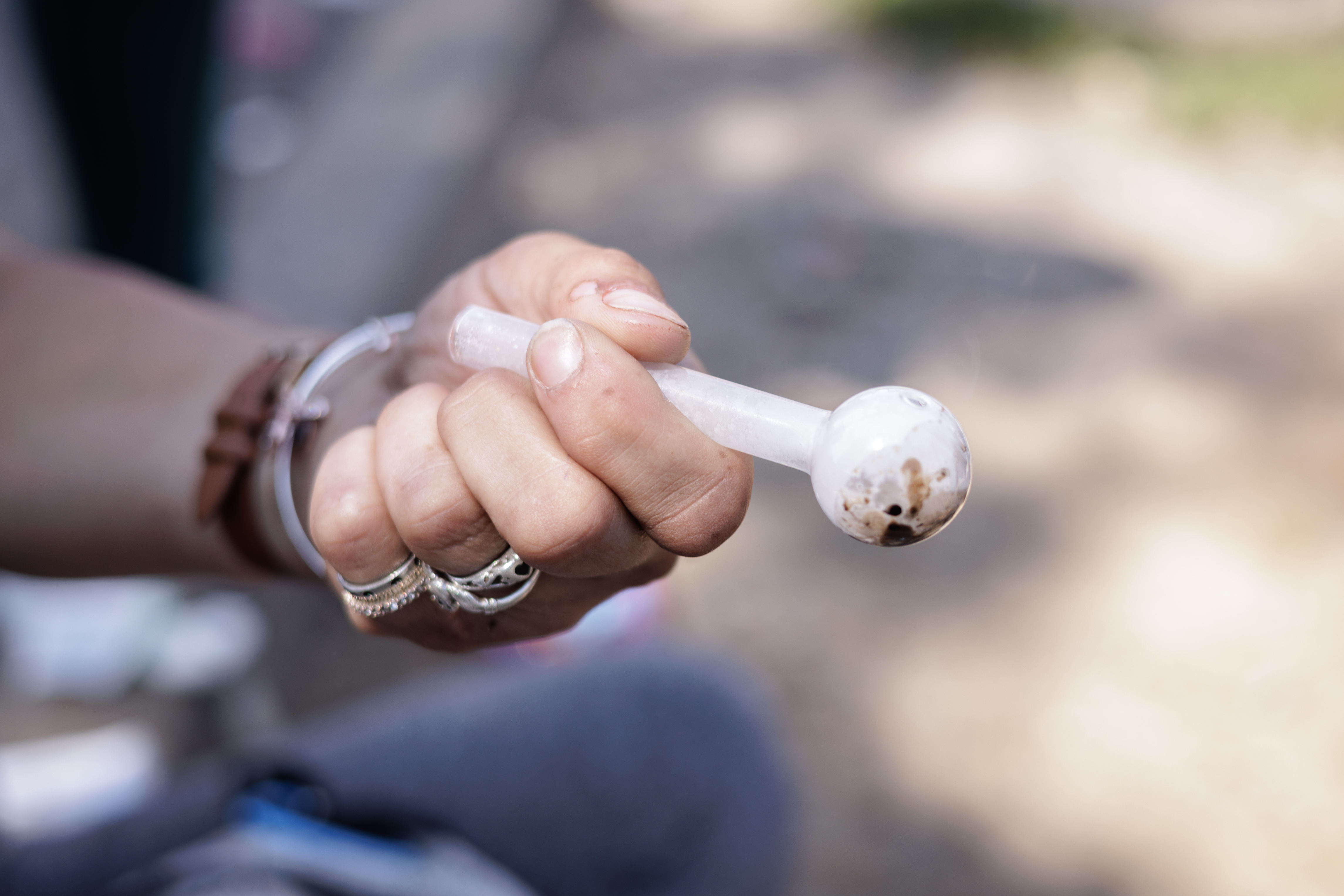 Glass pipe held in hand with rings