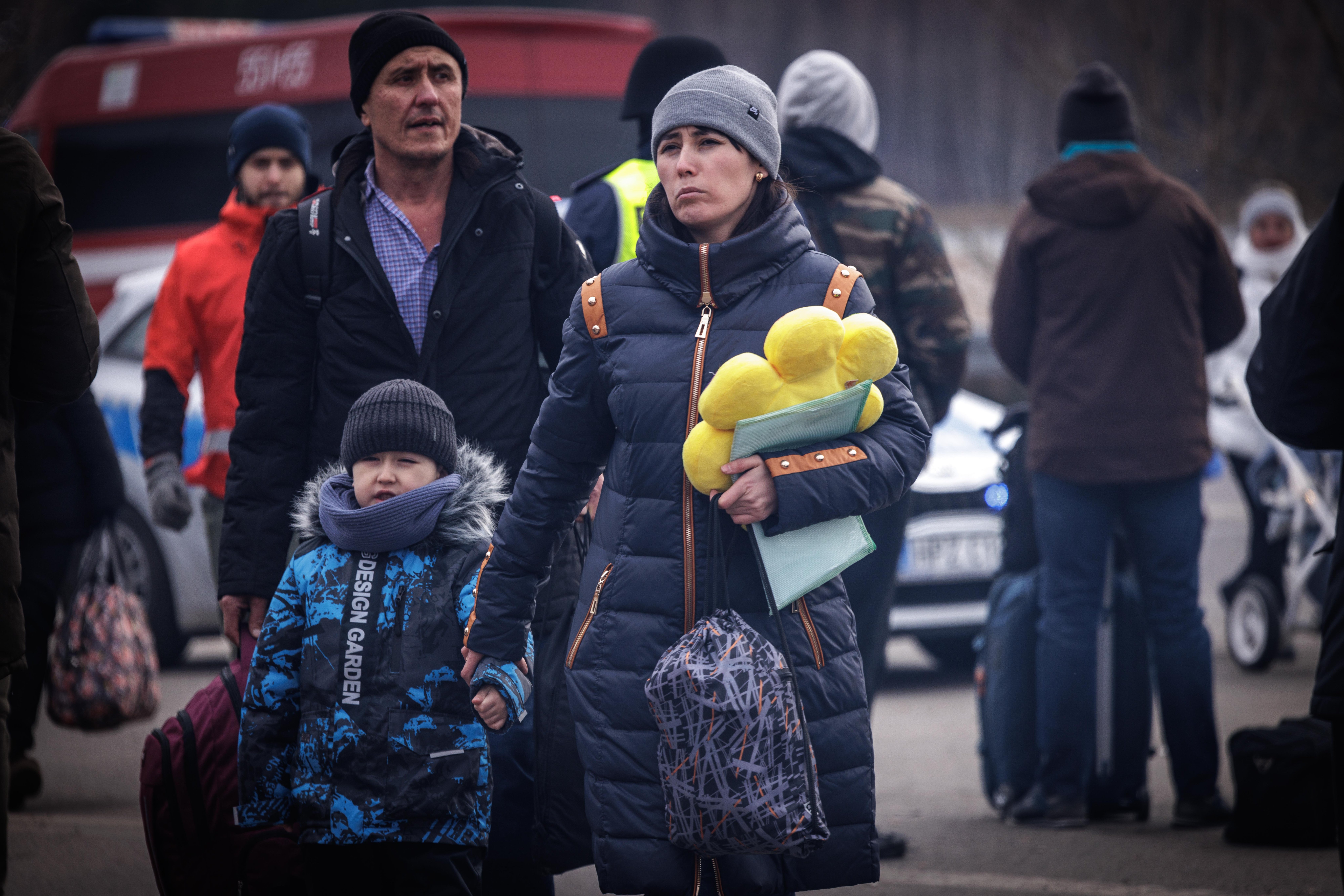 Family with child and stuffed duck at border