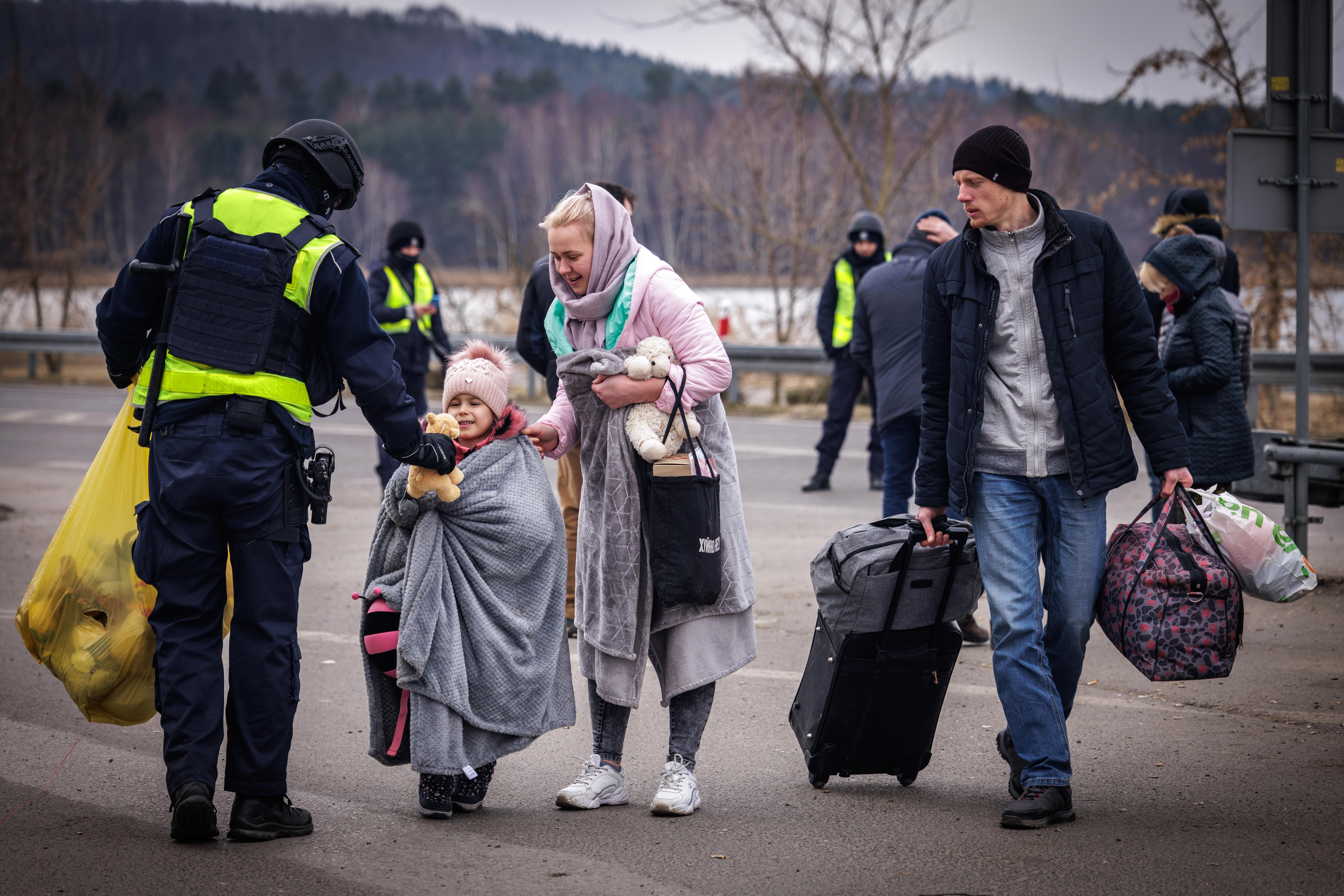 Family with small child and stuffed animals assisted by police